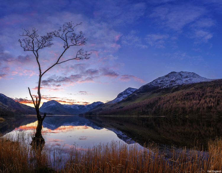 View across Lake Buttermere in the English Lake District at sunset.