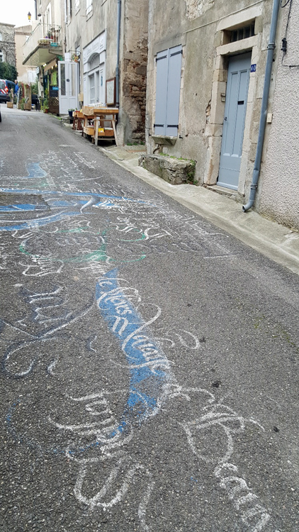 Montolieu - Writing on the road outside Museum of Book Arts & Crafts