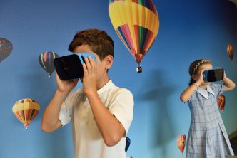 Boy and girl using VR headsets