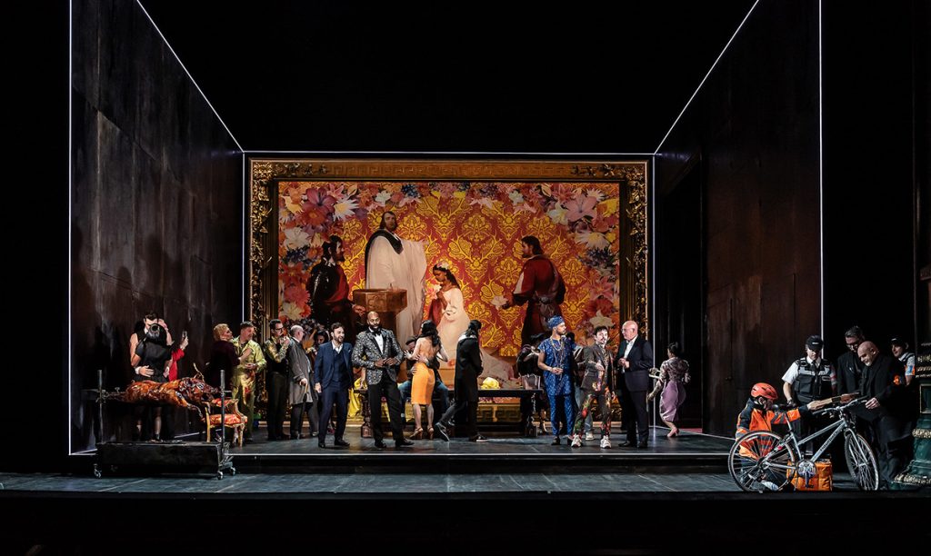 Opera North’s production of Verdi’s Rigoletto. Roman Arndt as Duke of Mantua, Eric Greene as Rigoletto, Themba Mvula as Marullo, Ross McInroy as Count Ceprano and Campbell Russell as Borsa, with the Chorus of Opera North. Photo credit: Clive Barda