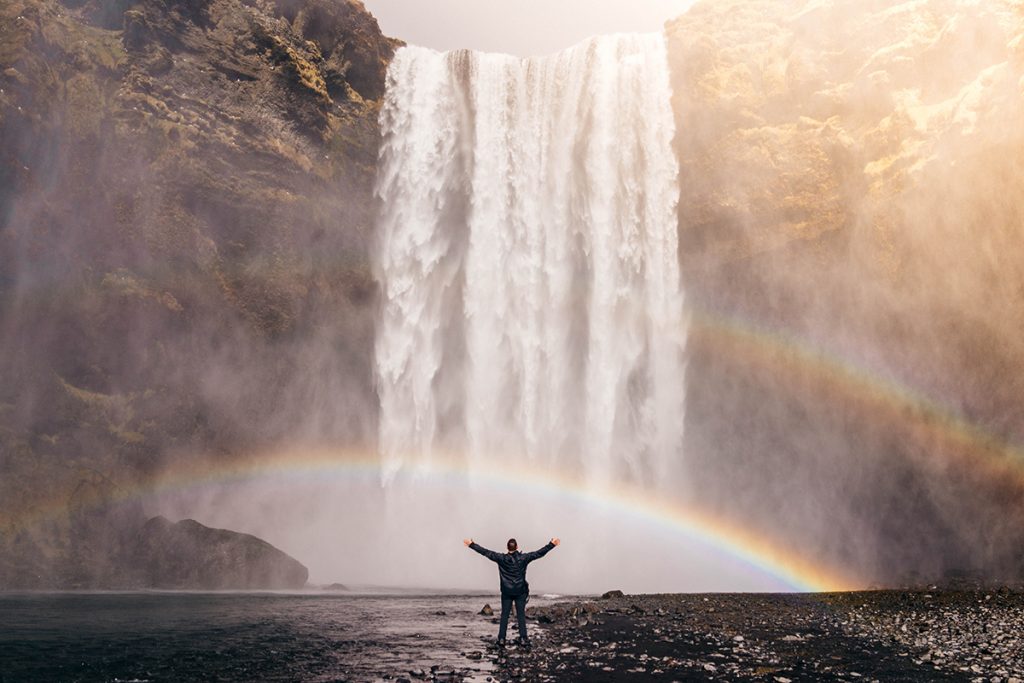 Man by waterfall Photo by Jared Erondu on Unsplash