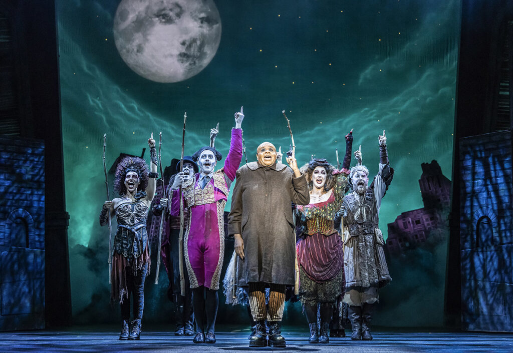 Clive Rowe as Uncle Fester (centre) with cast in The Addams Family UK Tour - Credit Pamela Raith