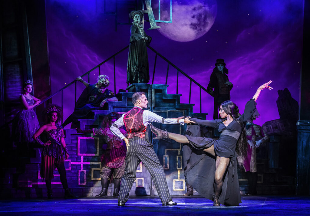 Ricardo Afonso as Gomez Addams & Alexandra Burke as Morticia Addams (centre) in The Addams Family UK Tour - Credit Pamela Raith