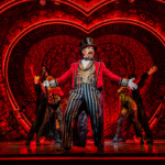 Cameron Blakely as Harold Zidler and the original world tour company of Moulin Rouge! The Musical Photo credit – Johan Persson