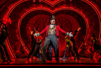 Cameron Blakely as Harold Zidler and the original world tour company of Moulin Rouge! The Musical Photo credit – Johan Persson