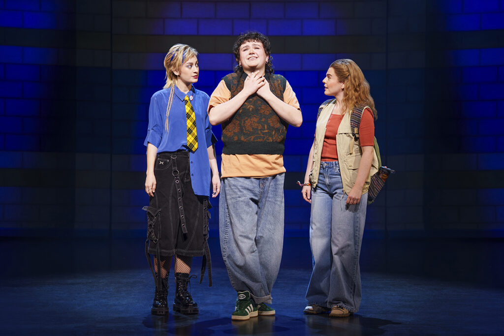 MEAN GIRLS THE MUSICAL. Georgie Buckland (Janis Sarkisian), Max Gill (Damian Hubbard) and Emily Lane (Cady Heron). Photo by Paul Coltas