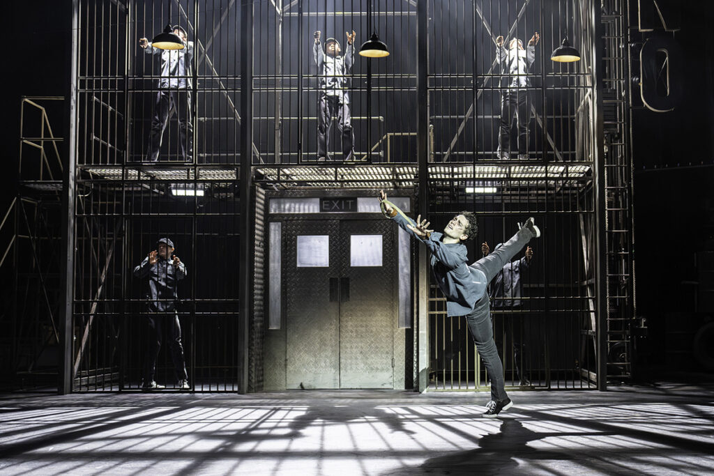 Matthew Bourne's THE CAR MAN. Leonardo McCorkindale (Angelo) and Company. Photo by Johan Persson