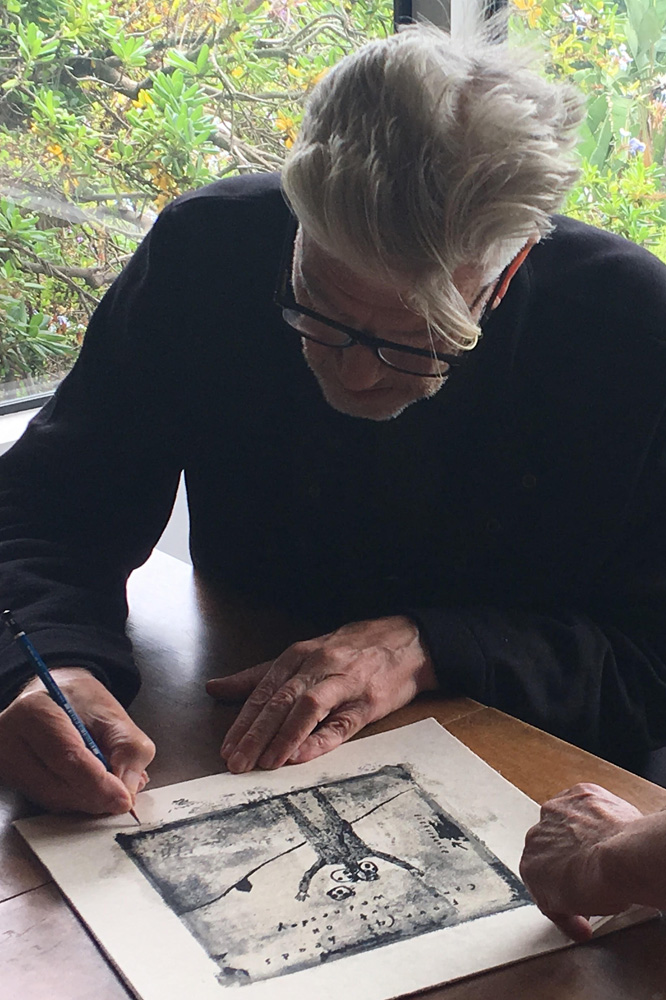 Lynch signing a print of Four (4) Heads Came Out on Wednesday 