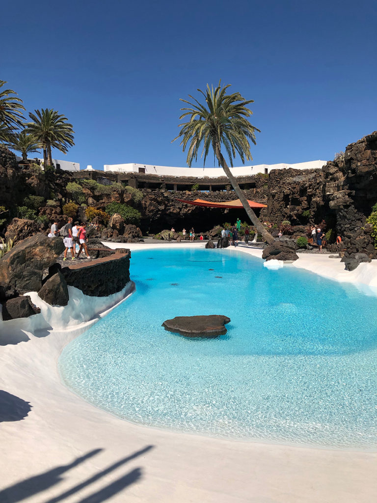 Jameos del Agua – white pool surrounded by palm trees is like a film set