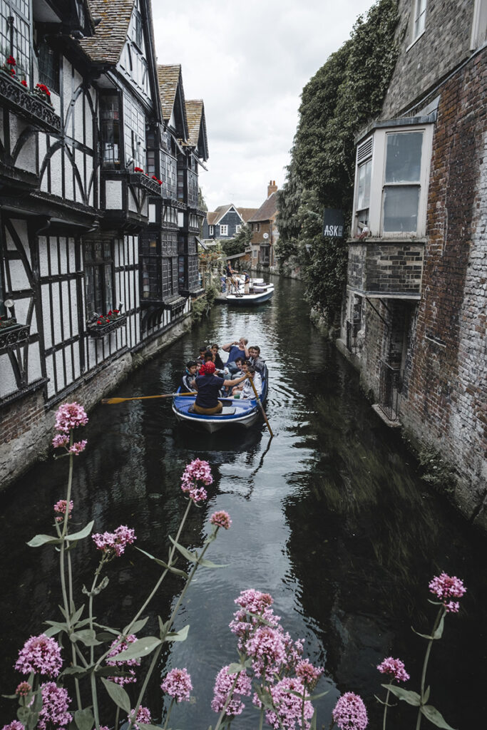 Boats rowing along a canal between houses in Canterbury, Kent, England Image credit VisitBritain/Katya Jackson