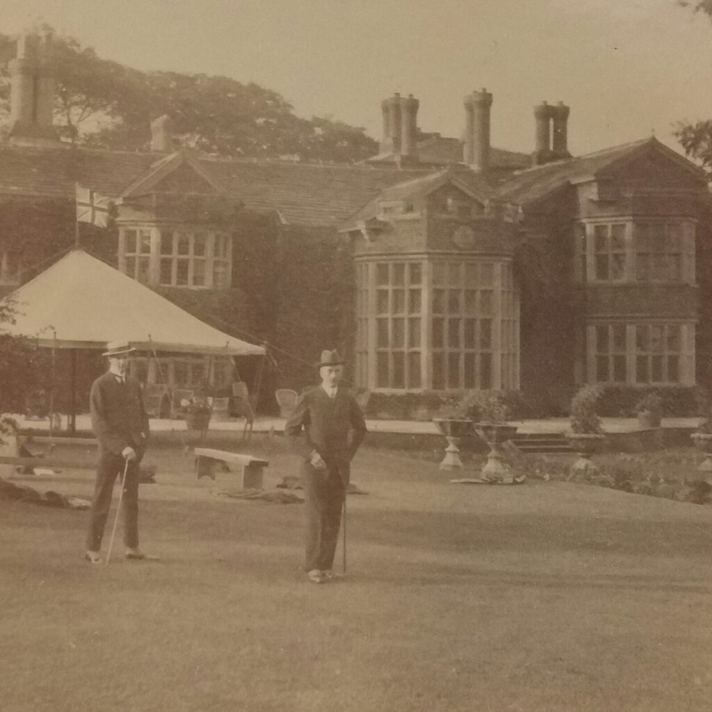 Men on the lawn at Hopwood Hall