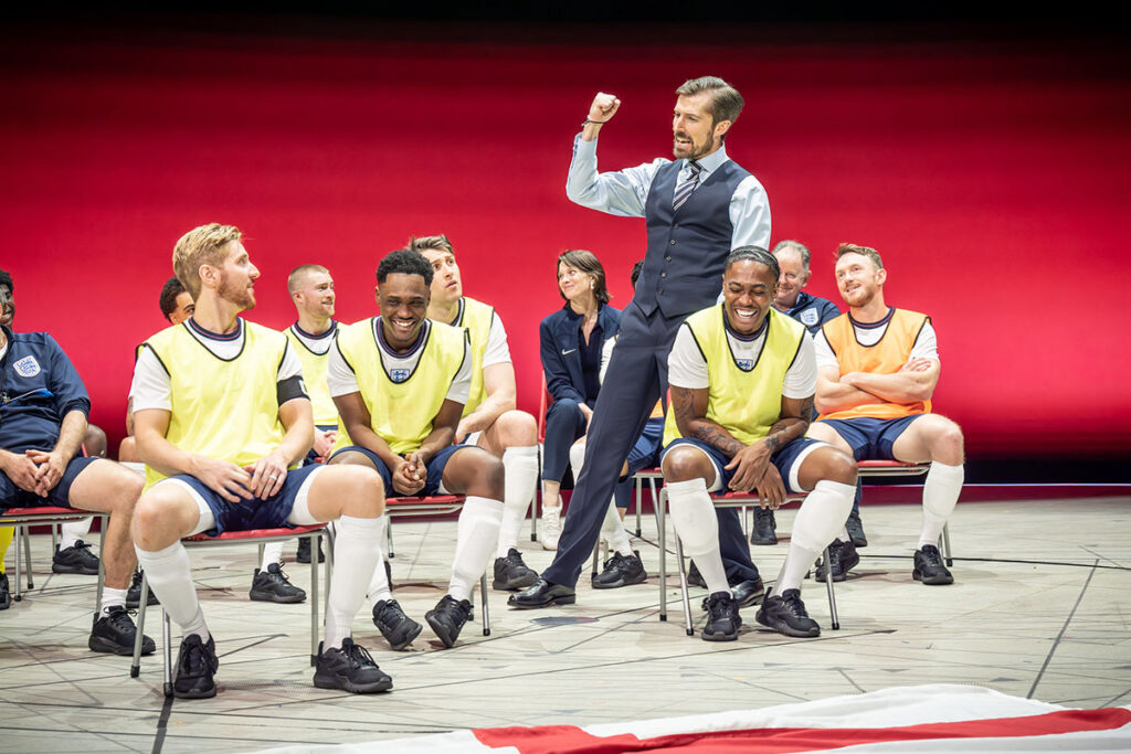 Gwilym Lee (Gareth Southgate) and company in Dear England (2025) at the National Theatre (c) Marc Brenner